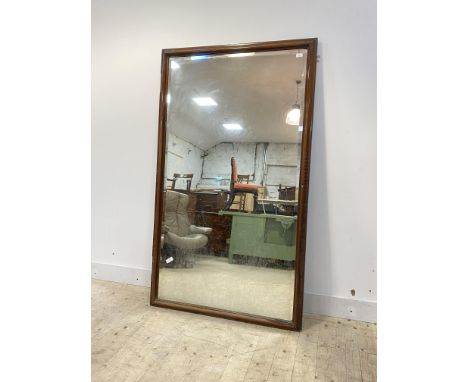 A large mahogany framed wall hanging mirror, early 20th century, with bevelled glass (converted) 180cm x 106cm