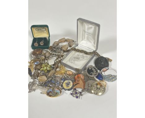 A collection of costume jewellery including marcasite circular brooch and floral spray brooch, a ceramic brooch, a vulcanite 