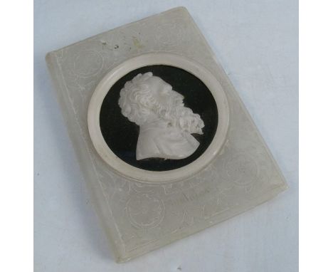 An alabaster paper weight, formed as a book, with carved portrait set on a black roundel, engraved Michelangiol, 5ins x 3.5in