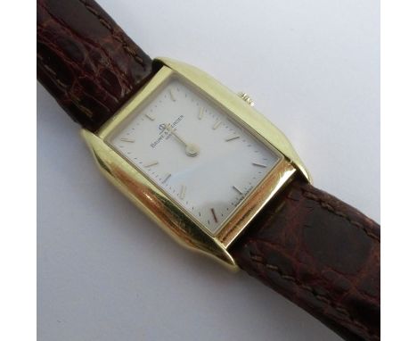 Baume &amp; Mercier, a ladies wrist watch of tonneau shape, the signed white dial with gilt batons and hands, stamped to the 