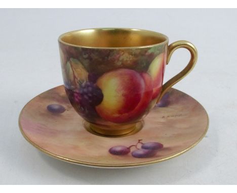 A Royal Worcester cabinet cup and saucer, the exterior of the cup decorated with fruit to a mossy background by H H Price, wi