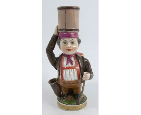 A 19th century Niderviller porcelain candlestick figure, modelled as a dwarf with a barrel on his head, a pen-holder at his s