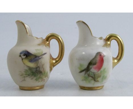 Two miniature Royal Worcester flat back jugs, each decorated with English birds, one signed Powell and the other signed&nbsp;