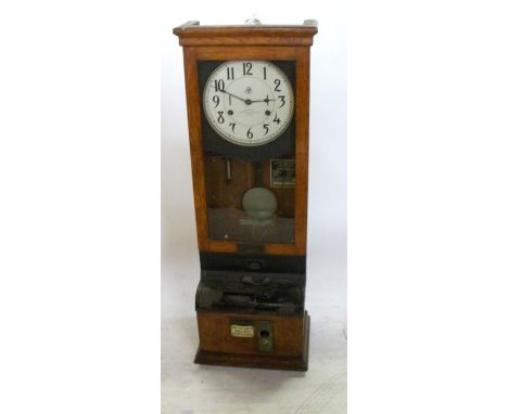 An International Time Recording Co Ltd London clocking in clock, in an oak case, height 44insCondition Report:  There is a wi