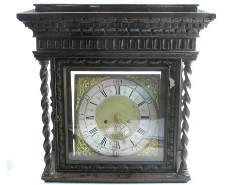 An Antique oak cased long case clock, the square brass dial having a silver chapter ring and inscribed Eli Handy, with carved