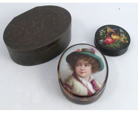 An oval tortoiseshell box, the pull off cover having a porcelain plaque decorated with a portrait of a person wearing a hat, 