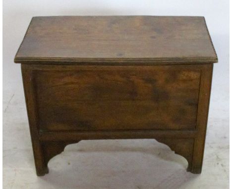 An Antique elm box, with chip carved ends to the hinged lid, with fielded front and raised on bracket feet, width 25ins, dept