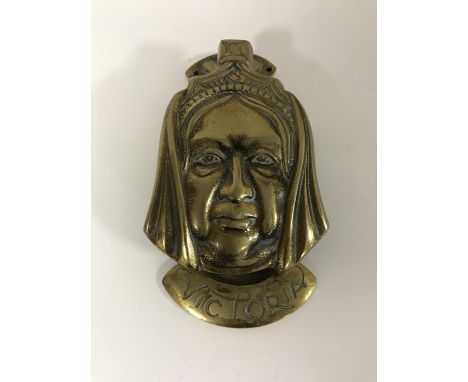 A Victorian brass door knocker in the form of Queen Victoria 
