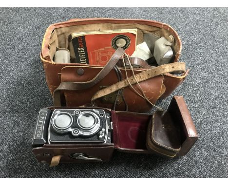 A Rolleiflex camera in leather case with original Rolleiflex guide, lens covers etc 