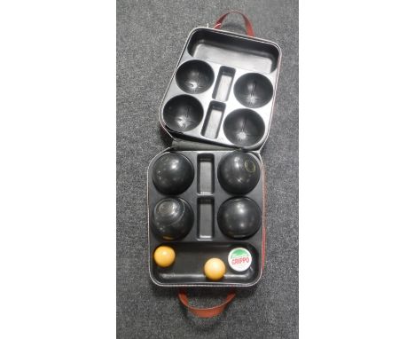 A set of four Dunlop Standard Woolf lawn bowls in case