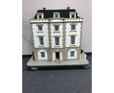 A good quality doll's Georgian style town house, on four storeys, containing many pieces of furniture including a piano and a
