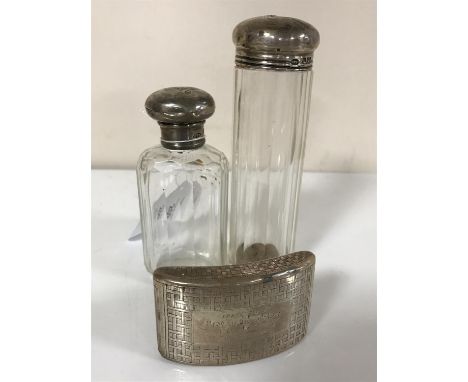 A Georgian curved silver snuff box and two silver-topped dressing table bottles