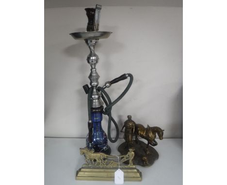 A hookah pipe, a brass blacksmith figure and a brass horse door stop 