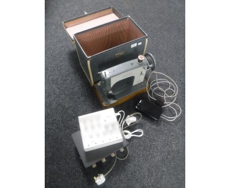 A cased Jones electric sewing machine, Adarstra solid state public address amplifier and a Uniross battery charger 