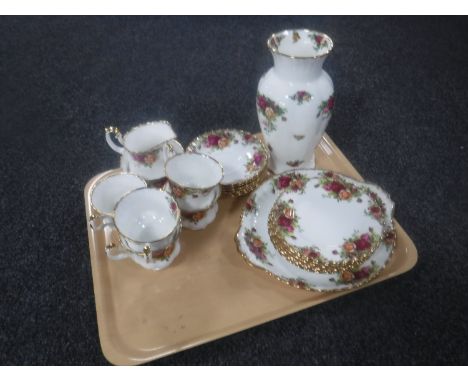 A tray containing a twenty-one piece Royal Albert Country Roses tea service, matching vase