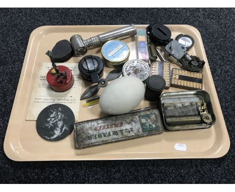 A tray of lacquered brass military compass, life boat matches, large egg, collectables etc 