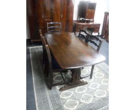 An Ercol refectory dining table and five oak ladder back chairs 