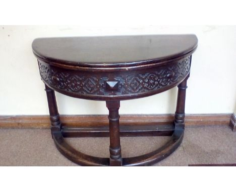 19th century Jacobean style demi lune table, fold-ove top with gate-leg action, carved frieze, turned and block supports, hei