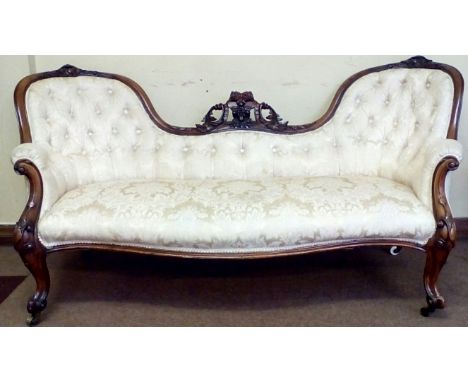 Victorian walnut double spoon back settee, scroll and leaf capped frame, knurled feet terminating on original brass castors h