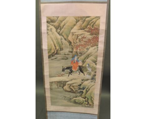 A 20th Century Chinese painted scroll decorated with a sage on horseback with attendants in river landscape.