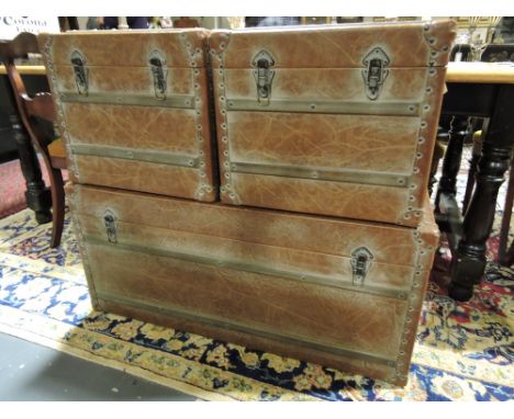 A vintage style studded wood bound tan leather trunk with black cloth interior, W. 100cm, together with two smaller similar.