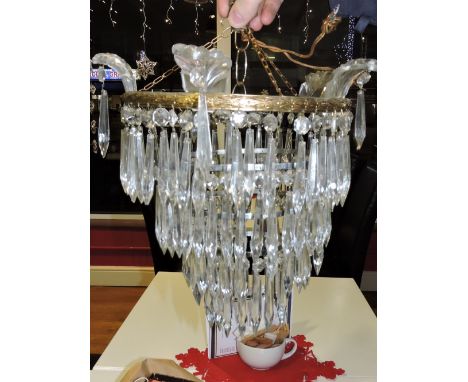A gilt metal 3 tier ceiling light hung glass icicle drops, a similar smaller shade with a matching wall light.