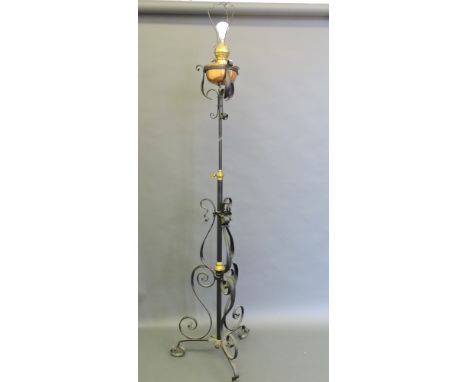 A Victorian wrought iron and copper adjustable standard lamp, converted for electricity, incorporating a copper reservoir on 