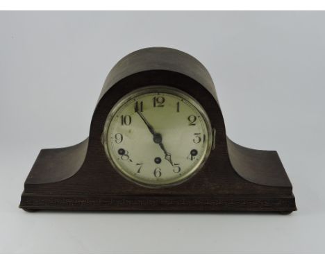 A 20th century oak mantel clock, the silvered dials set out with Arabic numerals, the movement fitted with a gong, W. 42cm.