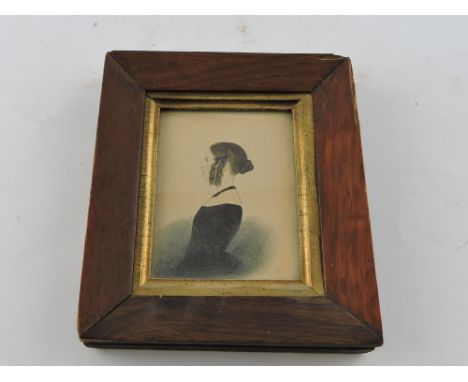 An early 19th century pen and ink profile miniature portrait of a young lady, rosewood framed, 10cm x 7cm.