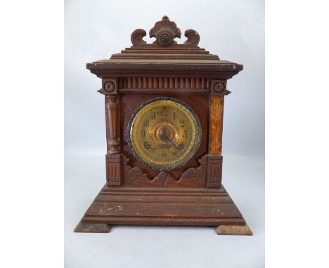 Wooden carved mantle clock with gold face and pendulum.  Marked Ansonia Clock Co. New York to workings.  Patented June 1882. 