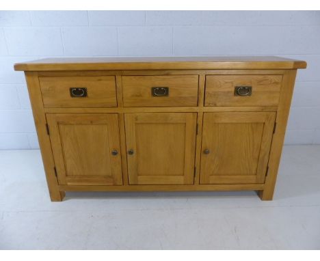Modern light wood sideboard with three small cupboards and three drawers over