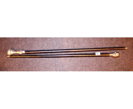 WALKING STICKS. Two silver topped walking sticks, skull and floral