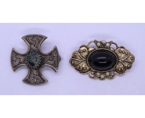 Silver Celtic brooch together with a yellow metal brooch 