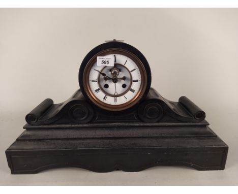 A large heavy slate mantel clock with enamel face, striking with key (some damage to enamel), 55cm long at base