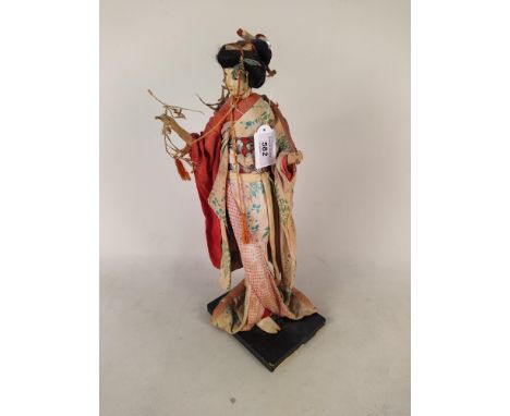 A vintage Japanese Geisha girl figure, all material construction including head dressed in traditional robes, 39cm high