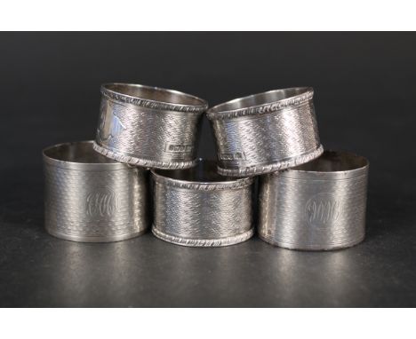 Three silver napkin rings with engraved raised decoration, hallmarked Sheffield 1903, maker Edwin Burrell plus two silver eng