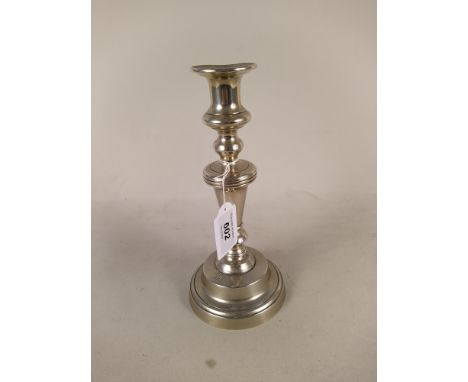 A late 18th Century Paktong candlestick with knopped stem and circular base engraved with ownership initials, 23cm high