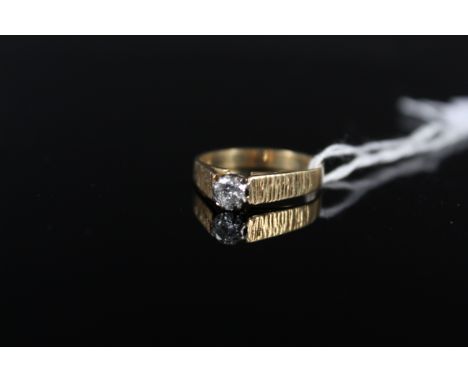 An 18ct gold solitaire ring with bark effect shoulders, size L, weight approx 2.5g