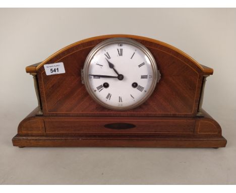 An Edwardian inlaid mahogany striking mantel clock