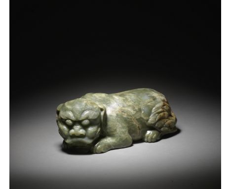 A MAGNIFICENT AND LARGE GREEN JADE MYTHICAL BEASTQing DynastyThe imposing animal carved recumbent with large bulbous eyes ben