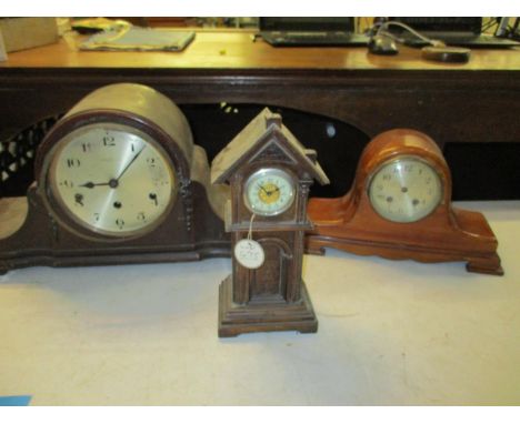 An early 20th century oak miniature long case clock polymer with a Winsor Bishop and Co mantel clock and one other A/FLocatio