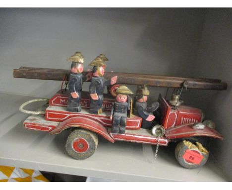 A 20th century painted wooden fire engine with eight firemen figures A/F (Condition: some woodworm damage, especially to one 