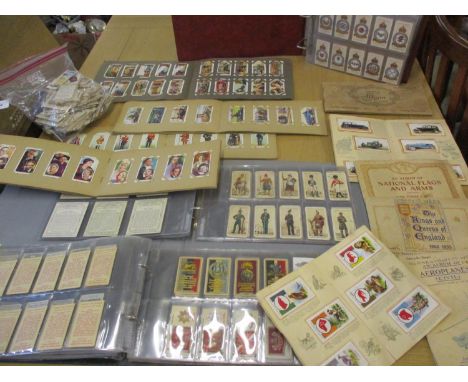 A collection of cigarette card album to include 1939 Gallagher Army Badge cards, 1939 Players Uniforms of the Territorial Arm