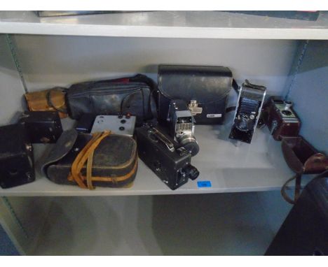 A group of box and folding film cameras, and movie cameras, along with vintage projectors and accessories to include a Cinete