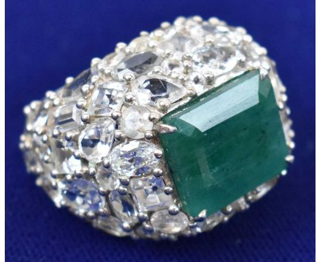 A very large Indian white sapphire and emerald dress ring, set in white metal, central stone approx 1.5 x 1.2cm, weight 22.3g