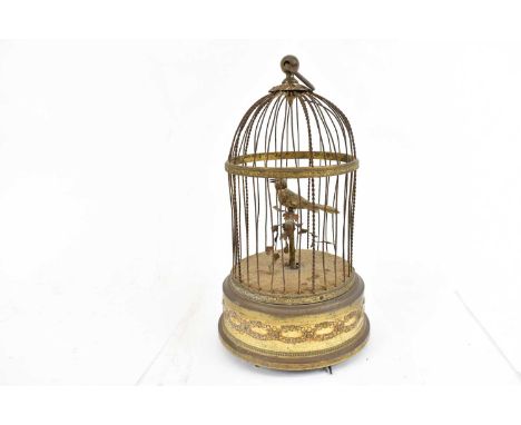 A vintage singing bird automaton in gilt metal cage, with moving head, beak and tail, height 28cm.Condition Report: Some bend