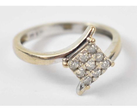 A 9ct white gold ring set with nine small stones, size L/M, approx 2.1g.