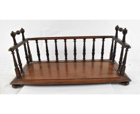 A William IV mahogany table top bookstand with twin handles and turned spindles, on bun feet, width 41cm.Condition Report: Ov