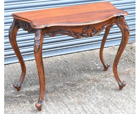 A reproduction console table of serpentine form, width 97cm.