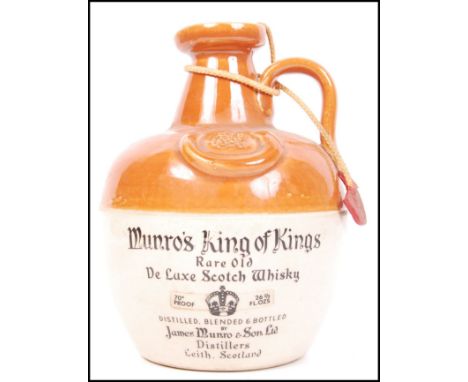 A ceramic flagon of Munro's King of Kings blended scotch whisky. Small chip to flagon to top. Sealed.&nbsp;